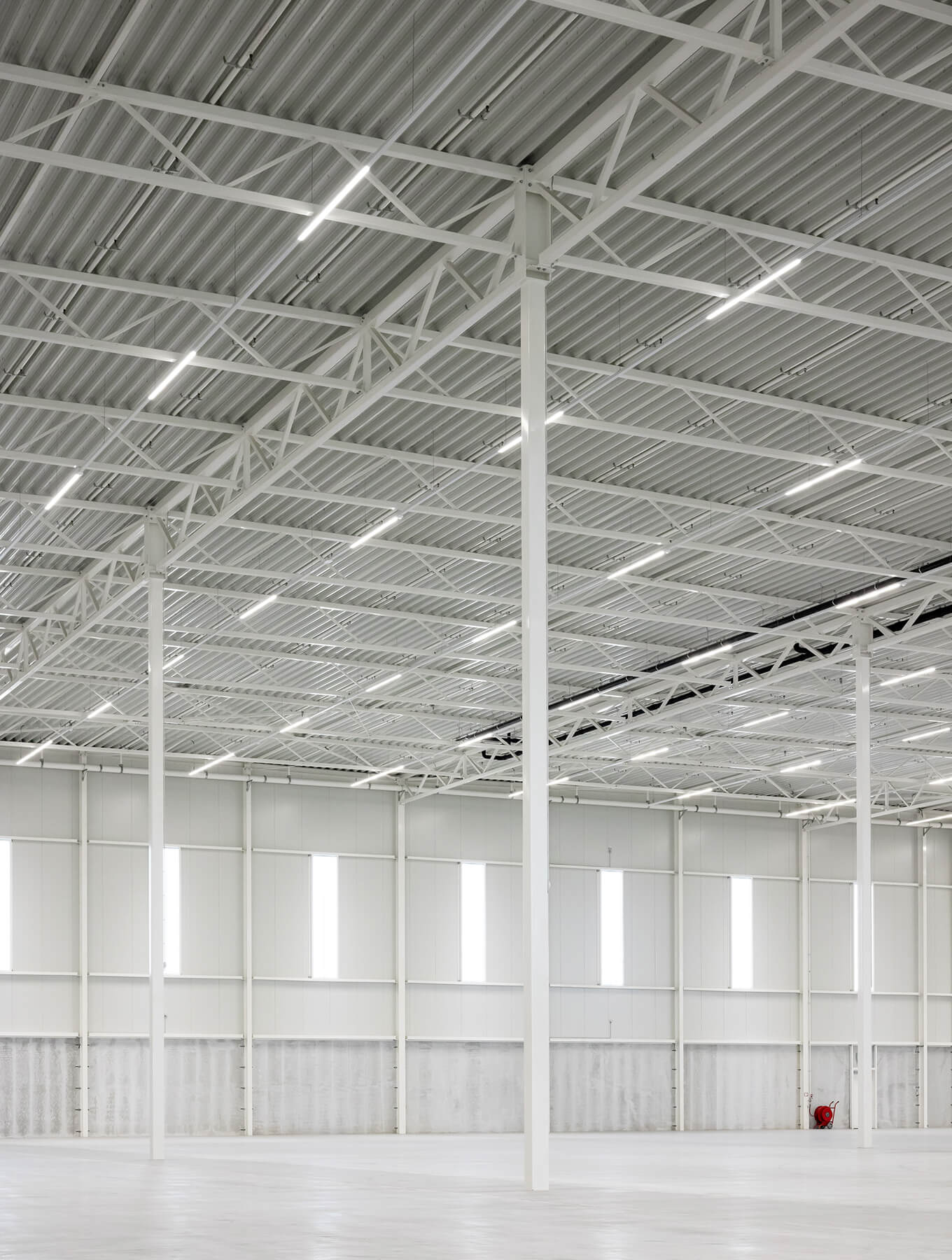 Light spacious clean white warehouse in the light of Capella